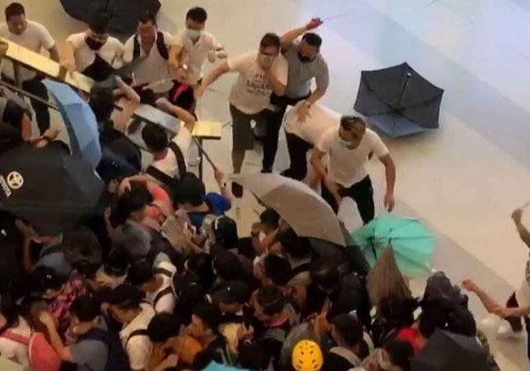 crowd of citizens defending against attacks from white clad men