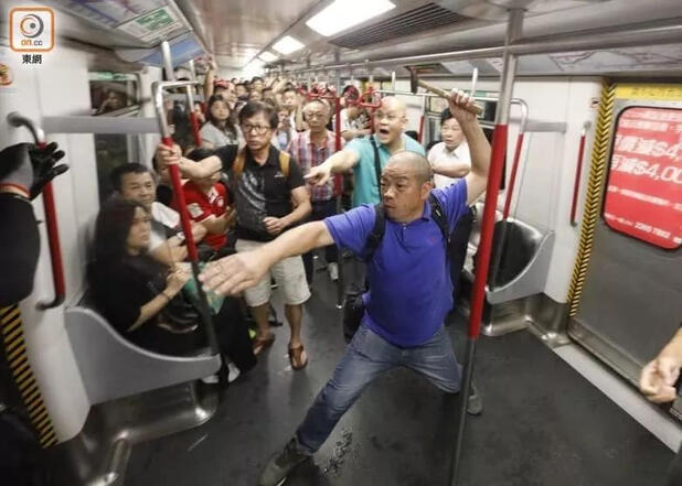 a middle aged asian man waving a hammer